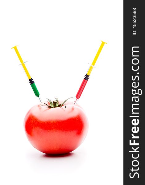 Syringe Injecting Red Green Liquid Into Tomato