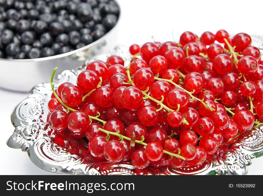 Fresh redcurrants on a silver isolated on white background. Fresh redcurrants on a silver isolated on white background