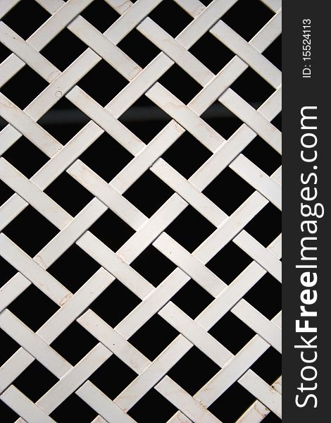 Lattice of white metal with a black background. Lattice of white metal with a black background.