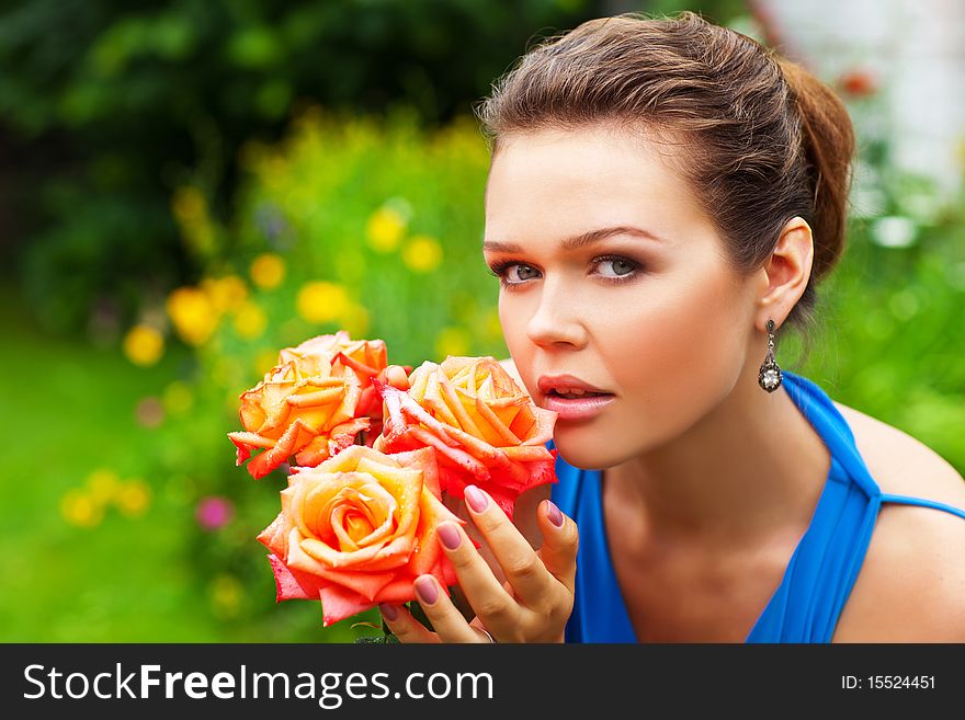 Pretty young adult smile to the camera and holding 3 roses in garden. Pretty young adult smile to the camera and holding 3 roses in garden