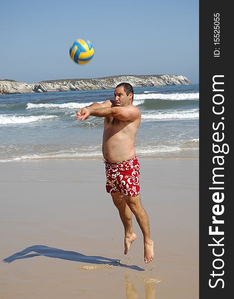 Fat Man Playing With A Ball On The Beach