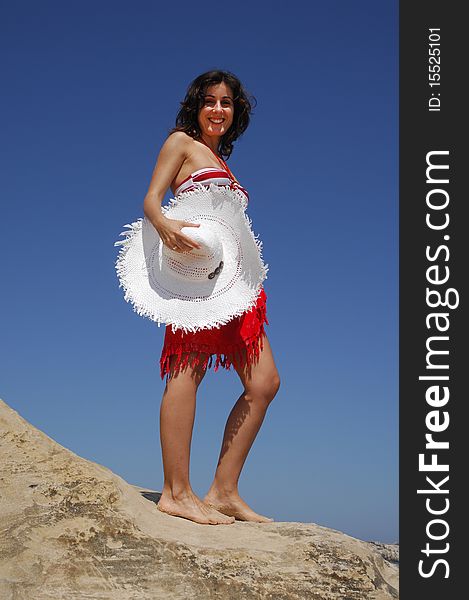 Beautiful girl on beach rock