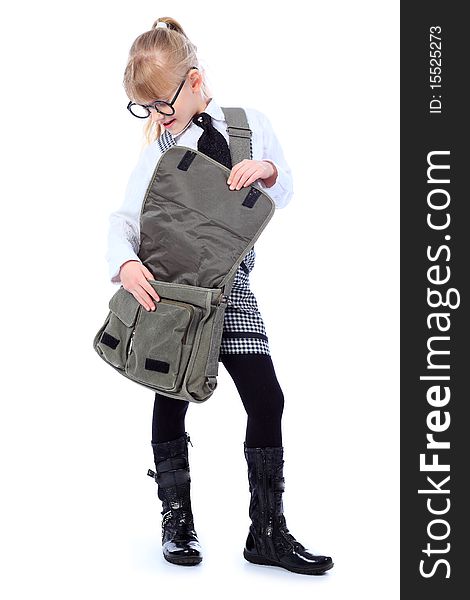 Shot of a little schoolgirl in glasses posing with her bag. Isolated over white background.