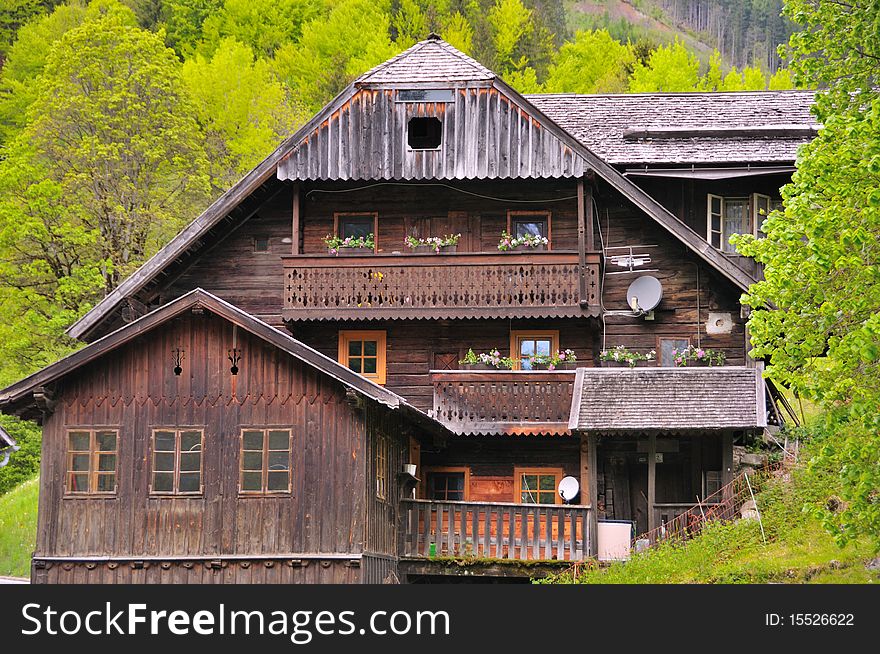 Wooden house with ornate balconies and window boxes in Austrian woods. Wooden house with ornate balconies and window boxes in Austrian woods