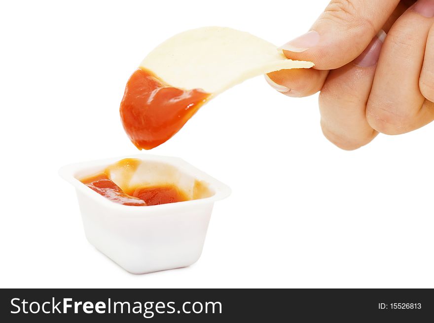 Potato chips in ketchup isolated on white background
