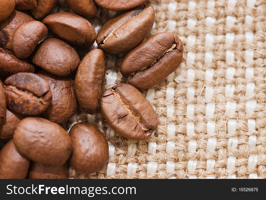 Brown coffee grains on a sacking close up