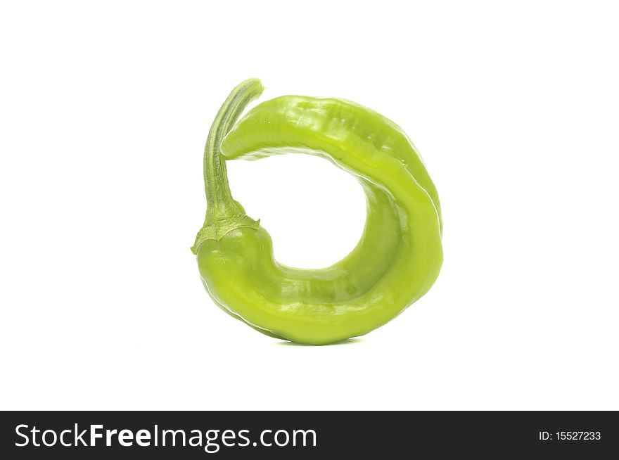 A green hot chili pepper isolated on a white background. A green hot chili pepper isolated on a white background