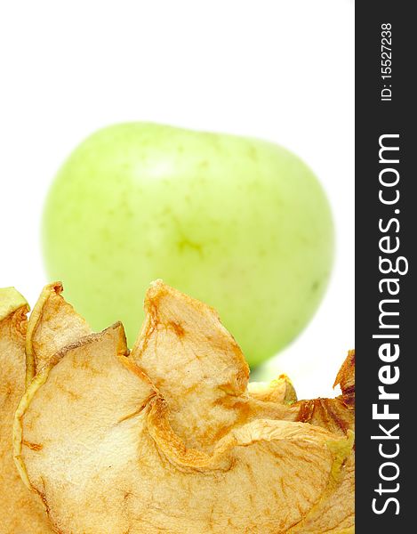 Dried aplles with a fresh green apple in the background. Dried aplles with a fresh green apple in the background
