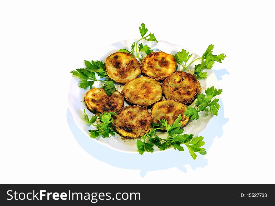 A Dish Of Fried Vegetable Marrow With Fresh Parsley
