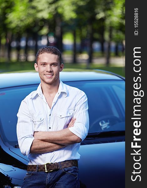 Attractive young man standing by car. Attractive young man standing by car