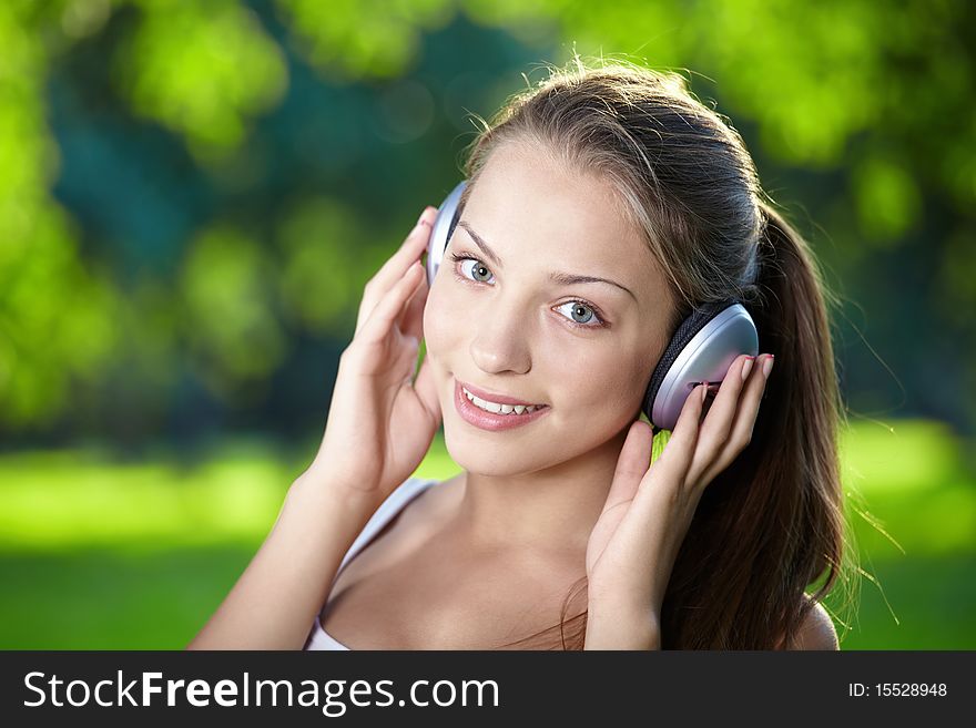 Portrait of a young girl listening to music with headphones. Portrait of a young girl listening to music with headphones