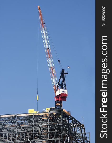 Large crane on large steel structure with blue sky background. Large crane on large steel structure with blue sky background