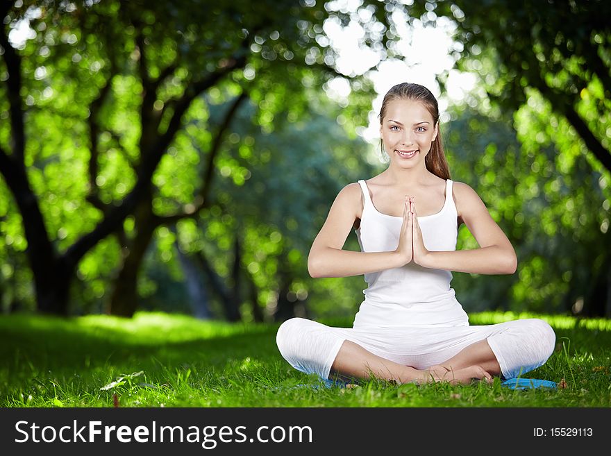 Young girl in lotus pose in the park. Young girl in lotus pose in the park