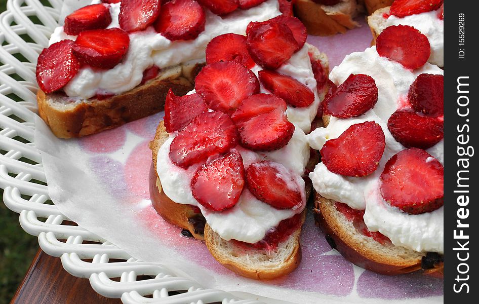 Delicious pastries with fresh strawberries and whipped cream. Delicious pastries with fresh strawberries and whipped cream