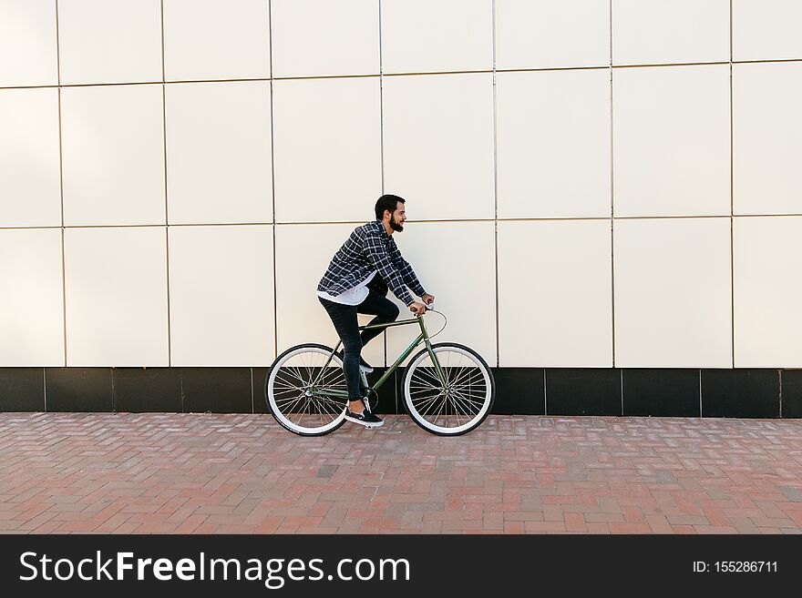 Side view of male riding a bike, outdoors