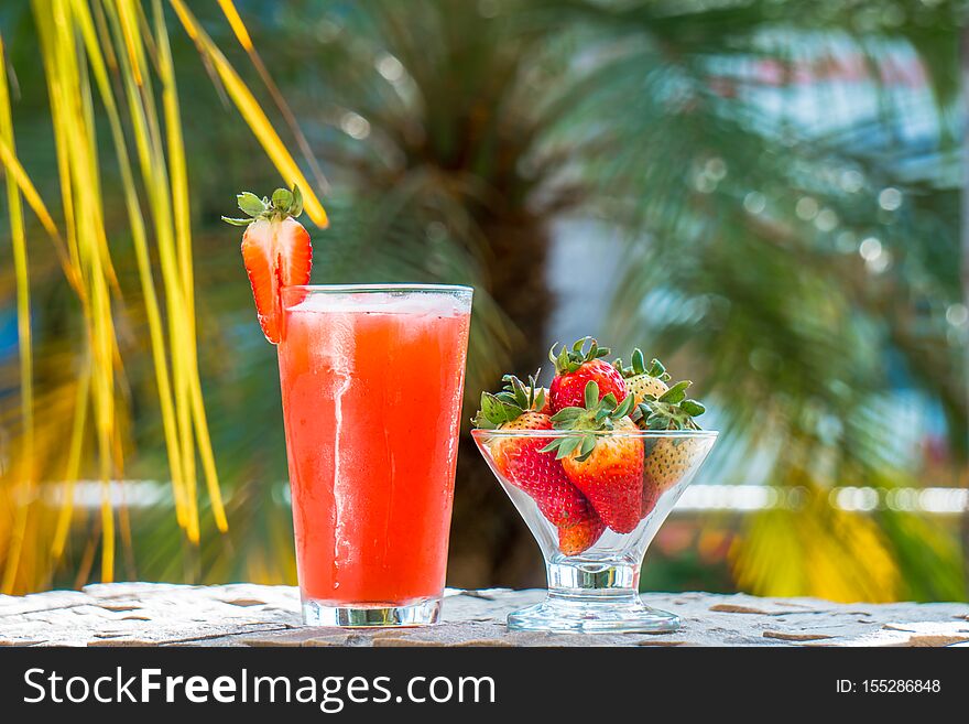 Strawberry juice and cup with natural strawberries