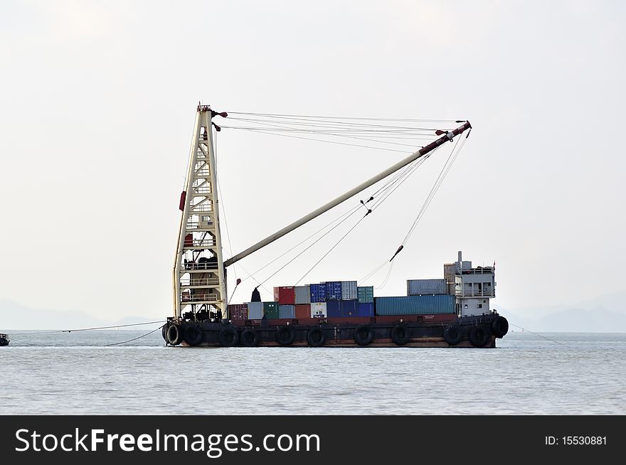 Container ship sailing into port in the morning