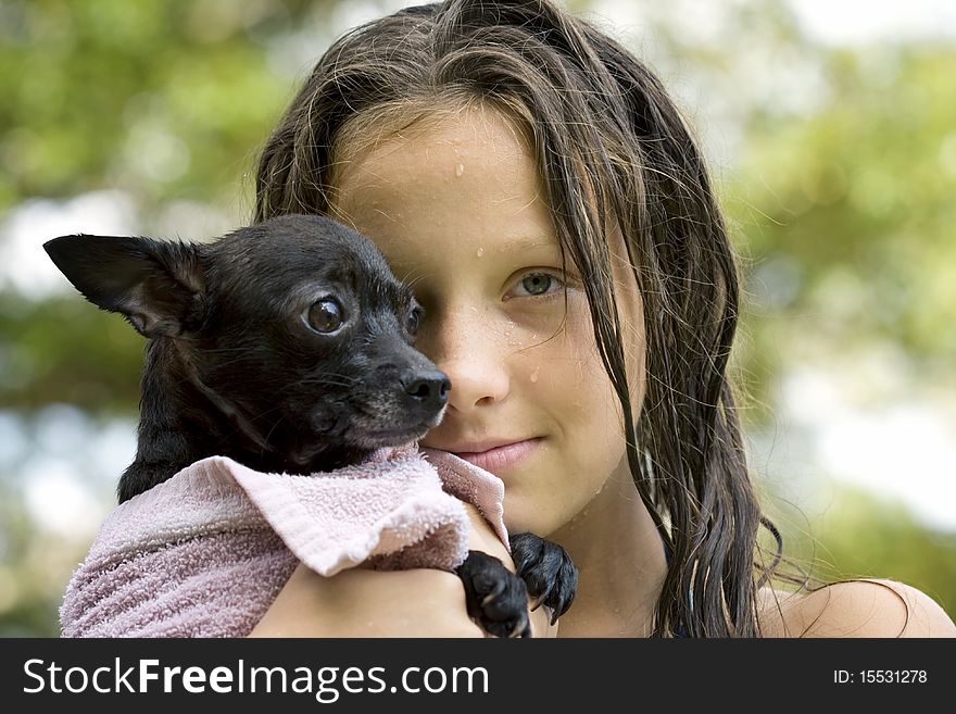 Young girl holding her puppy