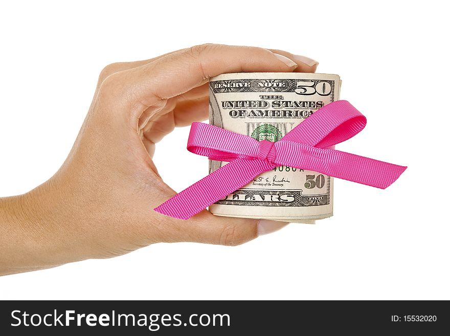 Hand holding bundle of dollars tied in a bow isolated on white. Hand holding bundle of dollars tied in a bow isolated on white