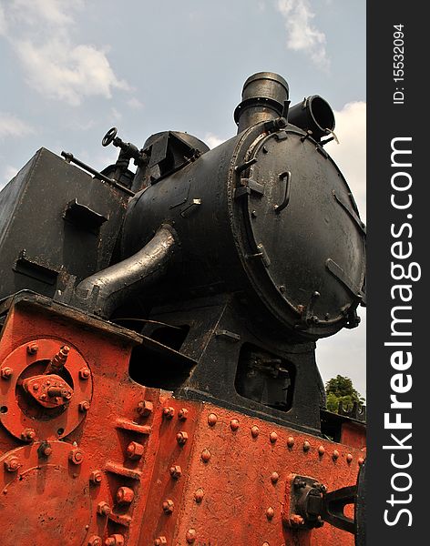 Front of a old locomotive transformed into a monument