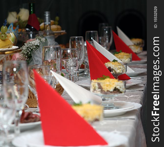 Festively covered table with red and white napkins. Festively covered table with red and white napkins