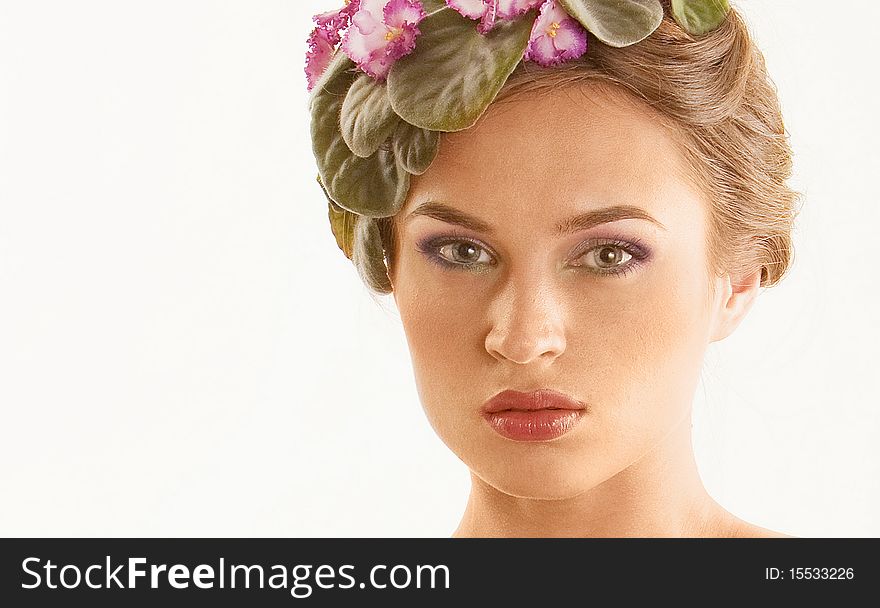 Portrait of beautiful girl with a wreath of flowers on her head