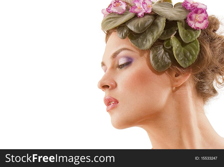 Portrait of beautiful girl with a wreath of flowers on her head