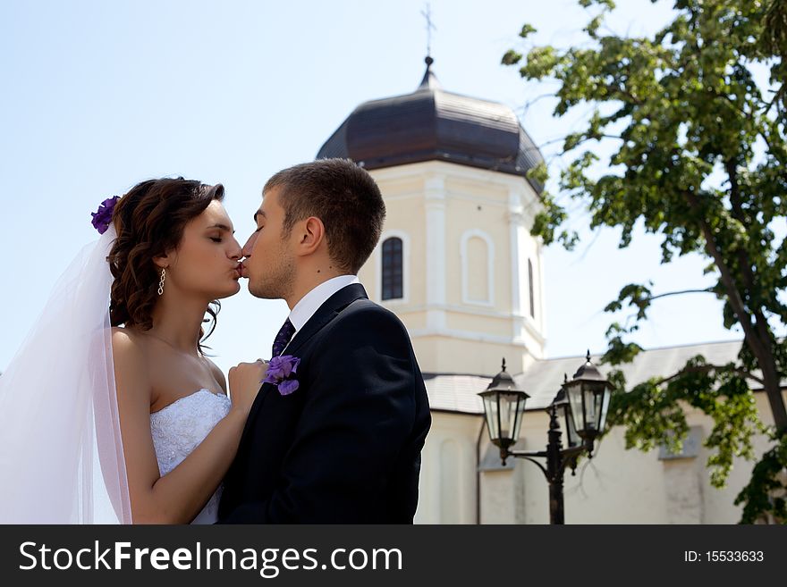 Bride and groom posing and kissing. Bride and groom posing and kissing