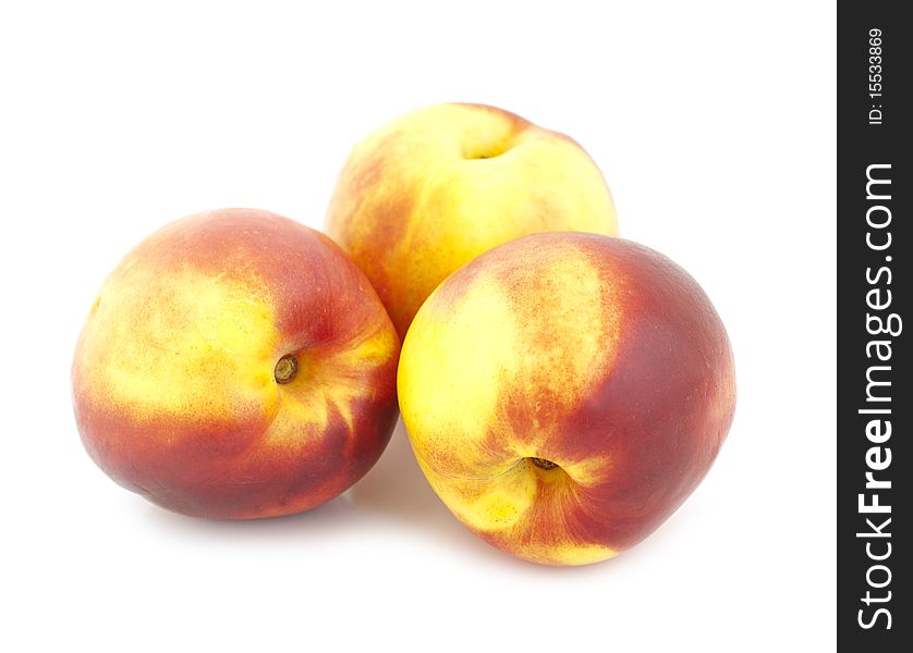 Three peaches on a white background