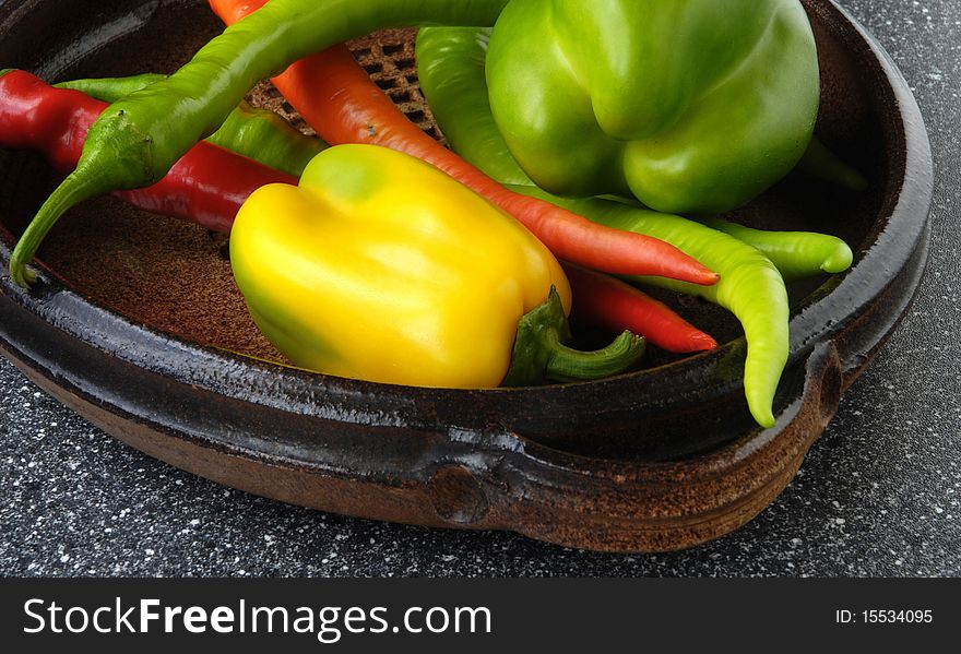 Vegetables, ceramic dish and chillies