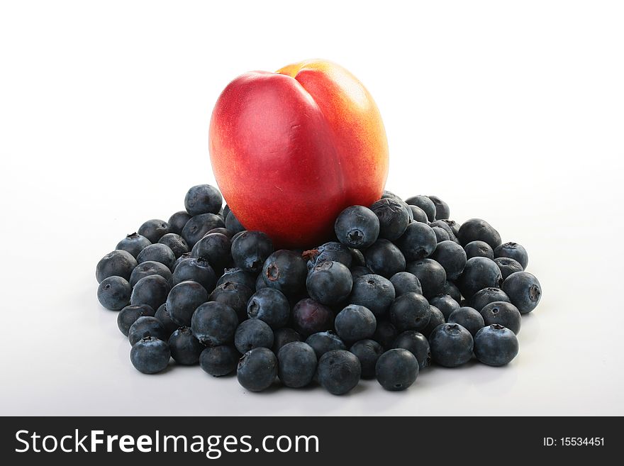 Red peach with blue berries of a blueberry. Red peach with blue berries of a blueberry.