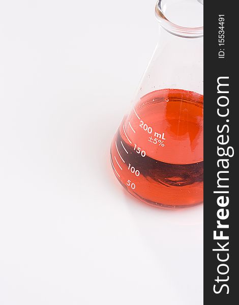 An erlenmeyer flask with red liquid on a white background. Add your text to the background.