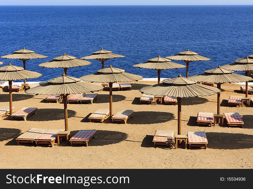 Empty sunbathe and beach umbrella in Sharm El Sheik. Empty sunbathe and beach umbrella in Sharm El Sheik