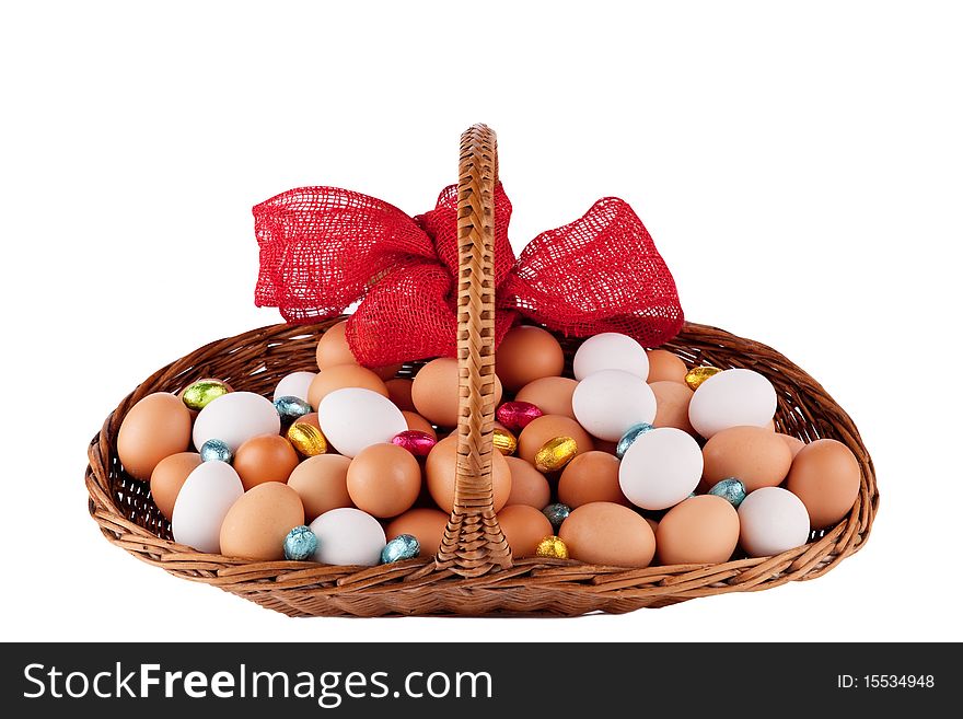 Easter Hens eggs in a basket with red Ribbon isolated on white. Easter Hens eggs in a basket with red Ribbon isolated on white