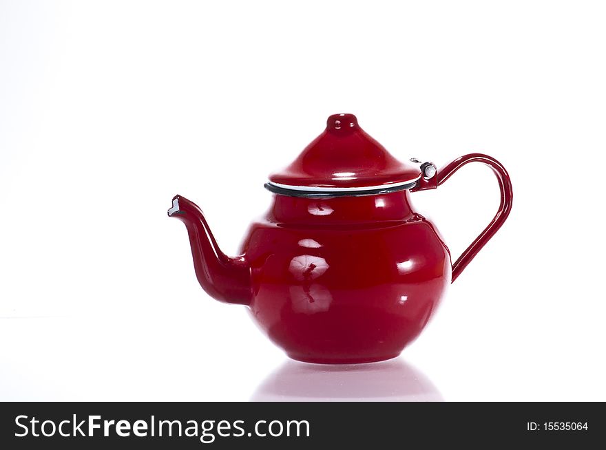 Old red metallic stylish teapot isolated on white background. Old red metallic stylish teapot isolated on white background