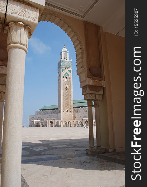 The towering minaret at Hassan II mosque in Casablanca is seen through an arch in the forecourt. The towering minaret at Hassan II mosque in Casablanca is seen through an arch in the forecourt