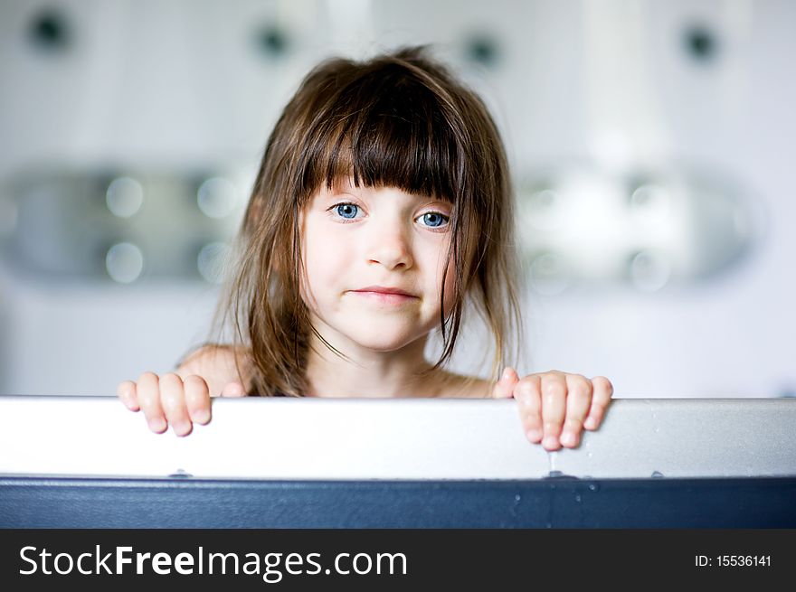 Nice toddler girl with blue eyes and dark hair in bath. Nice toddler girl with blue eyes and dark hair in bath