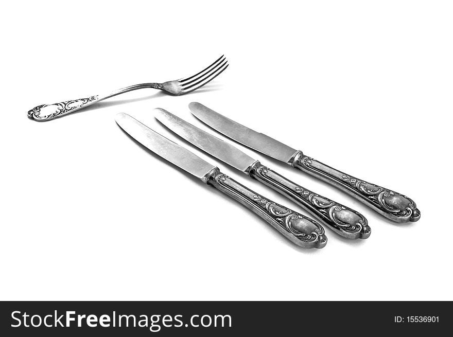 Three table knifes and fork on white background. This is raster image.