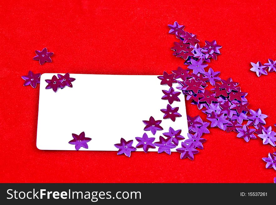 White card and violet stars on red background