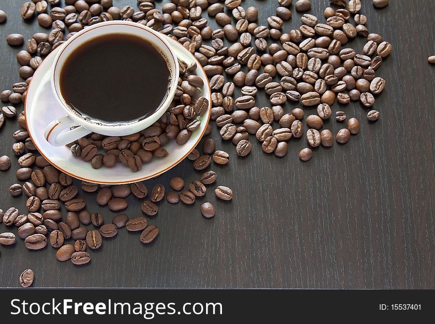 A cup of coffee on coffee beans background