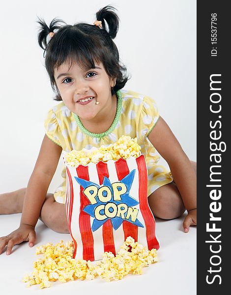 Sweet and cute toddler eating and enjoying pop corn. Sweet and cute toddler eating and enjoying pop corn