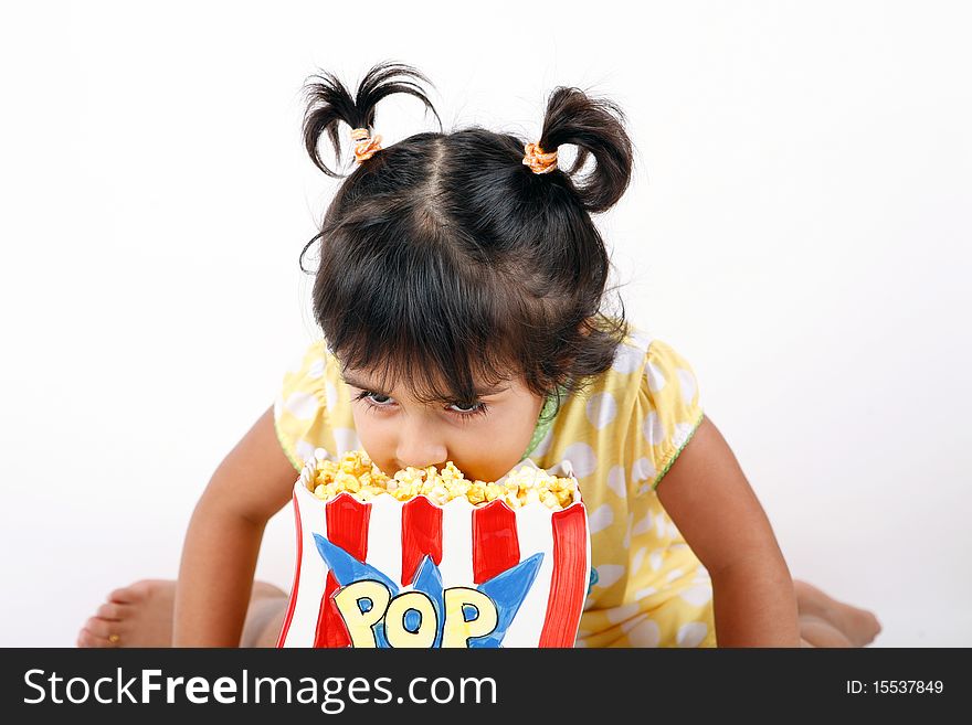 Sweet and cute toddler eating and enjoying pop corn. Sweet and cute toddler eating and enjoying pop corn