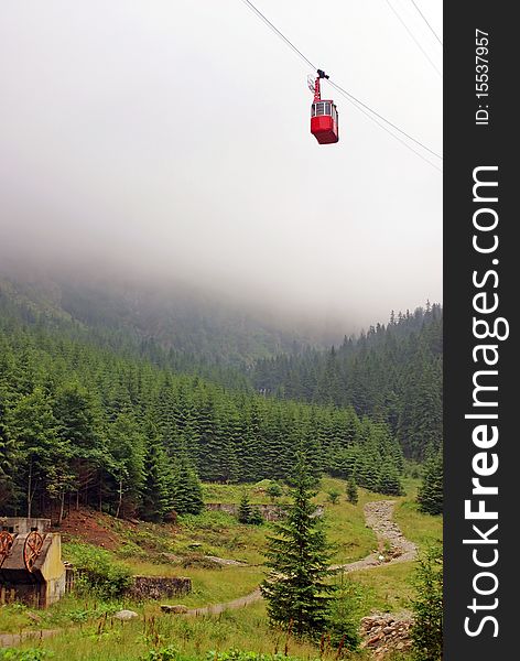 Cable car at high altitude in fog mountains