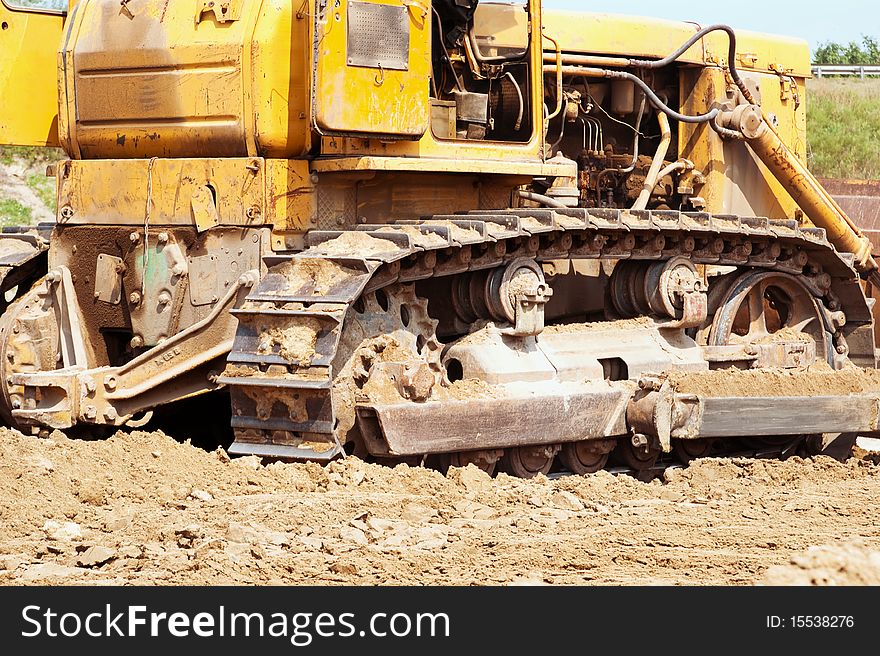 Bulldozer treads creap past at an urban sprawl construction site.PLEASE EMAIL ME to let me know how you used my photograph. I would appreciate it very much!! THANKS. I appreciate your feedback! Please rate this image if you download it.