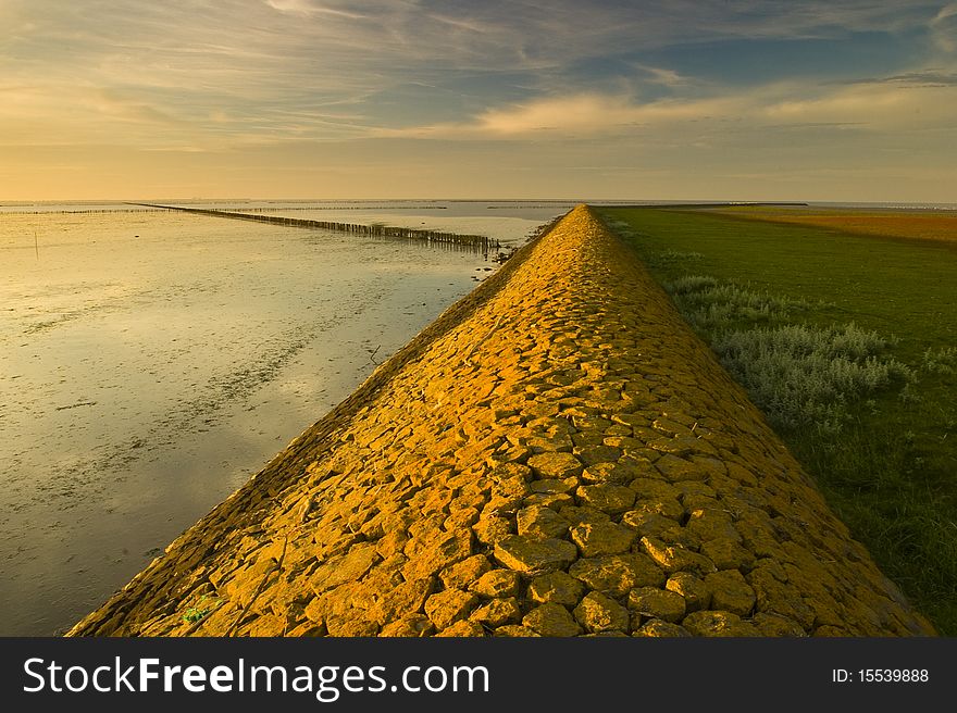 A yellow coloured embankment in warm light at sunset. A yellow coloured embankment in warm light at sunset