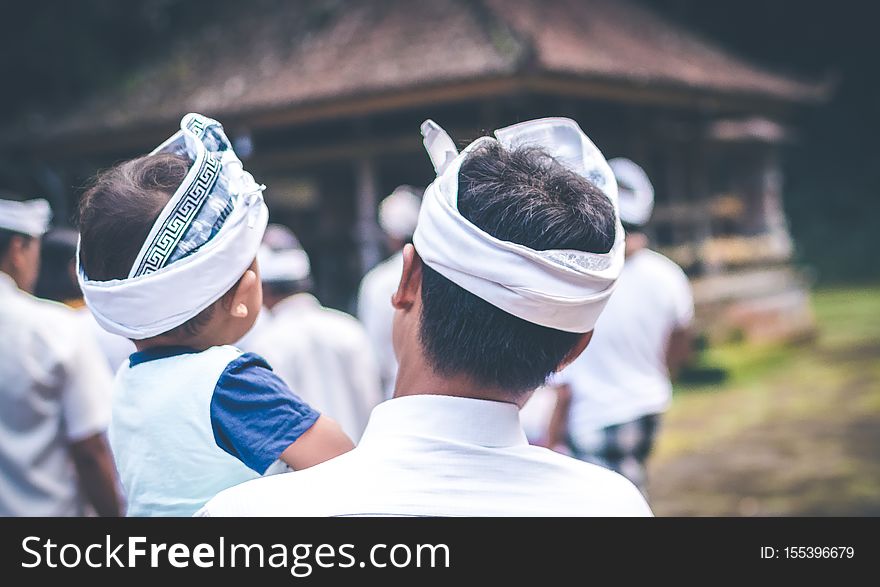 BALI, INDONESIA - JULY 4, 2018: Balinese Children On A Traditional Ceremony. Baby With Father.