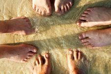 Feet Of A Family In The Fine Sand Of The Beach Royalty Free Stock Photography