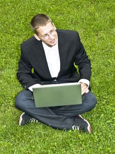 Young Businessman On The Grass With His Laptop Stock Photo Young Businessman On The Grass With His Laptop Stock Photo