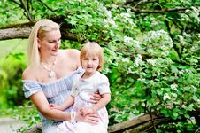 Mother And Daughter In Blooming Garden Royalty Free Stock Photography