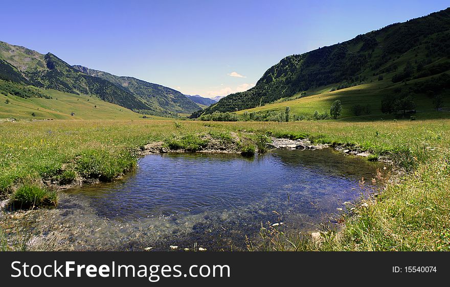 Calmed river water in small valley of the mountains. Calmed river water in small valley of the mountains
